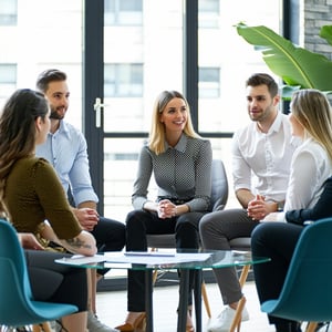 recruitment officers men and women in office setting gathering around for a team meeting