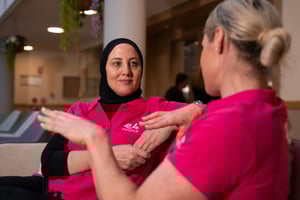 Two E4 nurses on sofa talking to eachother 4